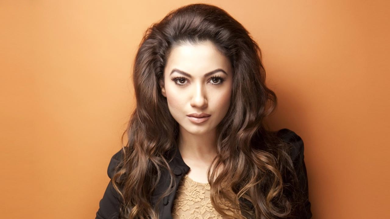 Gauahar Khan shared stunning pictures of herself in a transparent shirt from her Maldives vacation. See photos